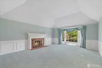 Views of the lovely living room featuring a beautiful traditional brick surround fireplace.