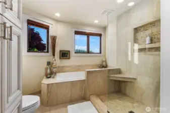 Tile wrapped soaking tub & custom shower w/seamless design.