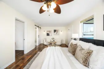 The upper level primary suite with mini split heat/ac and ceiling fan