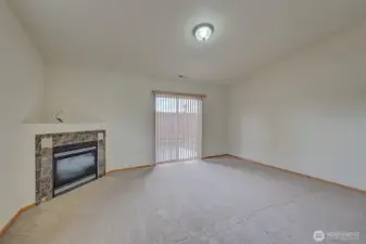 Family Room with Corner Fireplace & Sliding Door