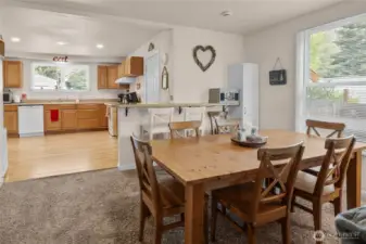 Dining area between kitchen and living room. Tons of light due to large windows through out.