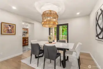 Formal dining leads right to an expansive deck, that was built around a tree!