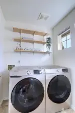 Laundry with shelving. W/D stay!