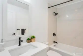 Main bath features new deep soaking tub, quartz tub surround, all new faucets/hardware, flooring, lighting and cabinetry.