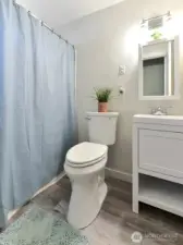 downstairs main full bath.  New floor, new vanity, new toilet, new light, new paint