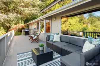 A wraparound deck surrounded by evergreens offers peaceful privacy — perfect for morning coffee, sunset dinners or weekend grilling.
