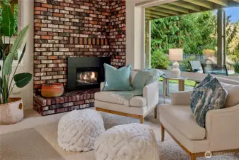 Cozy fireside seating with a timeless brick hearth, the ideal spot to curl up with a book or enjoy quiet evenings.