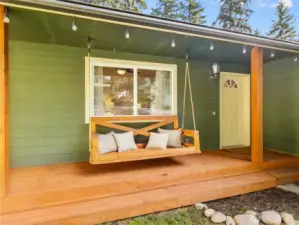 Covered porch with seating offers year-round enjoyment and a warm welcome for guests.