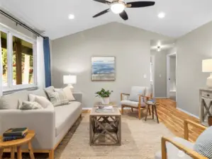 Bright and airy living room with vaulted ceilings, large windows, and open-concept flow.