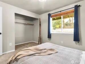 Second bedroom with plush carpet and calming natural tones.