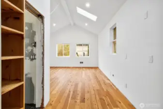 View walking in from the garage area with the unfinished bathroom on the left and open space and natural light welcoming you into the unfinished room