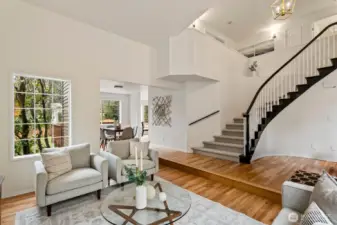 Dramtic 2 story foyer with curved bridal stairway. Brushed gold birdcage chandelier.