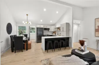 Vaulted ceilings with recessed lighting illuminate the open-concept living space in this light rail accessible Shoreline property, just one mile from the 148th Street Station with direct routes to Sea-Tac and downtown Seattle.