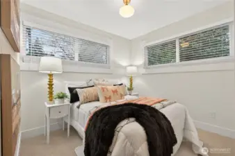 Spacious primary bedroom with abundant natural light.