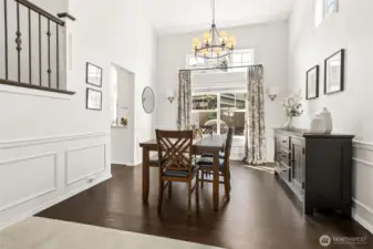 The shadow box detail, impressive lighting fixture, and plethora of windows make this dining room extra special.