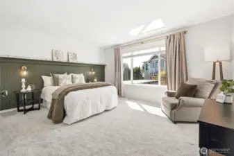 The expansive primary suite received an intentional artistic upgrade with the custom beadboard wall with display shelf.