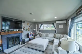 Cozy living room with room for ample seating and fireplace.