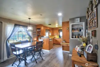 Dining area with lots of light and roomy kitchen.