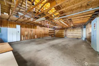 4-car garage has storage units and workshop area.