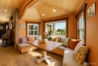 A bright and inviting breakfast nook with natural light and cozy seating, perfect for casual meals or morning coffee while overlooking the surrounding views.