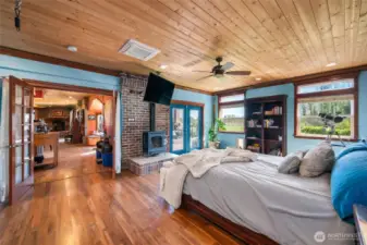 Primary suite with gas fireplace, spa-like bath, and serene garden views.