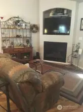 Gas fireplace and TV area off of the primary bedroom