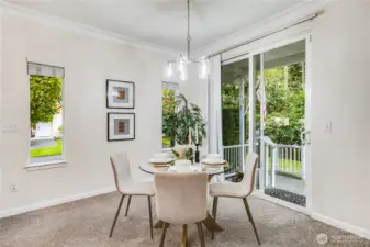 Situated right next to the sliding glass door, the dining area offers gorgeous views of the tall Northwest firs and greenery behind the home.