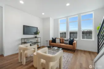 Great Room floor plan (second level). Abundance of windows throughout floods the home in natural light.  Photos are of model home of similar floorplan. Color scheme and layout will vary.