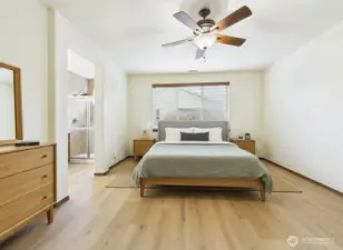 Spacious primary suite has loads of space for the largest of bedroom sets and still have room for a seating area.