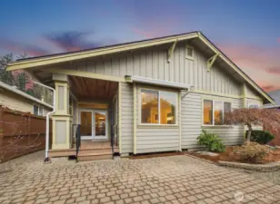 View of the back of the home.  Covered deck plus expanded tiled patio and walkways.
