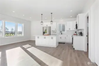 The kitchen is beautiful with quartz countertops and tiled backsplash.