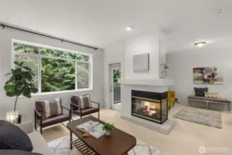 Family & living room share a gas fireplace & high ceilings