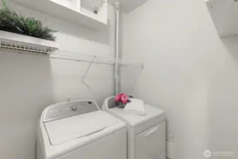 In unit Laundry with full size washer and dryer and storage shelves