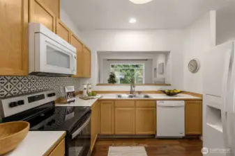 Kitchen has lots of storage. stainless steel range and stainless steel double sink