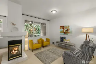 Family & living room share a gas fireplace & high ceilings