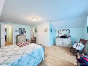 Upstairs oversize bedroom next to the bathroom with two walk-in closet areas.