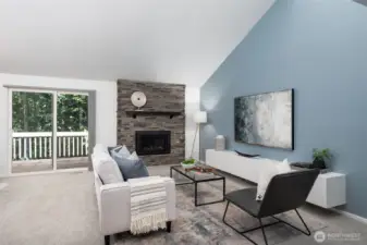 Living room with gas fireplace and vaulted ceilings.