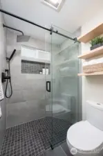 Large updated shower is tiled from floor to ceiling and boast pure luxury.