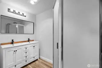 En suite bath with walk in shower and double sinks