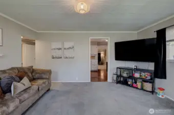 Bright main living area with large windows and comfortable gathering space.