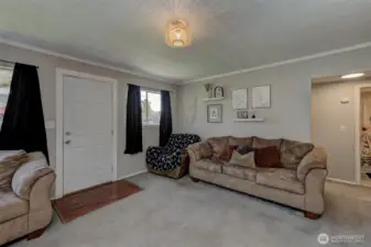 Bright main living area with large windows and comfortable gathering space.