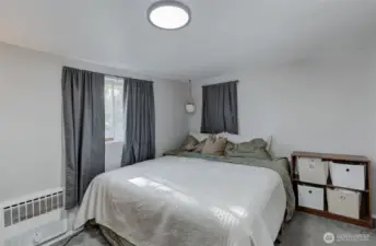 Comfortable main-level bedroom with ample natural light.