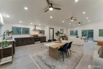 Open-concept living, dining, and kitchen with high ceilings. Wired for island