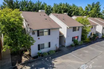 Aerial view showing the building, parking and surrounding neighborhood.