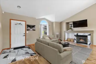 Spacious living room with gas fireplace and vaulted ceilings.