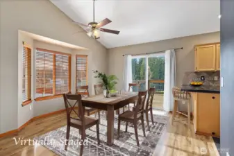Dining area off the living room is vaulted with bay window and slider.