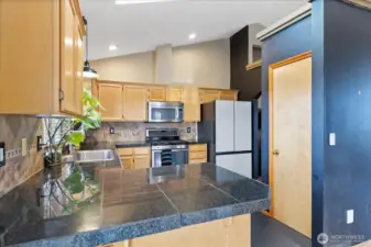 Another view of the kitchen with pantry to the right.