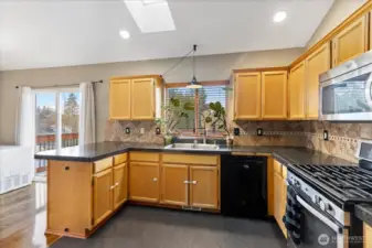 The kitchen window looks out over the back yard and Tuscany Ridge park.