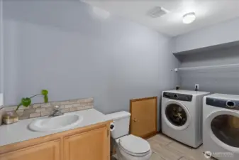 Half bath and laundry room off the lower rec room area.
