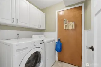Laundry room with cabinet storage.